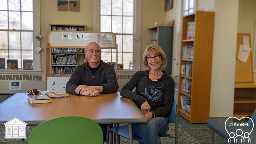 Alan and Sue smiling in the picture book room